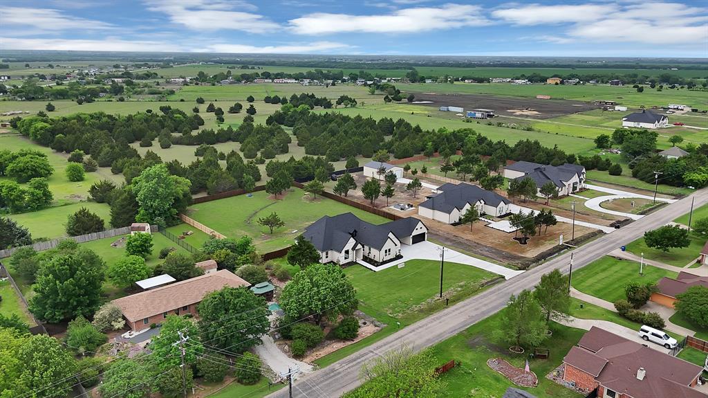 710 Gibson Road Waxahachie, TX 75165 - Photo 2 of 36 Aerial view showcasing the property's location within a verdant landscape, featuring extensive green spaces and surrounding trees