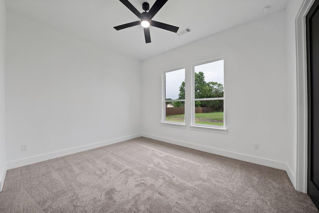 710 Gibson Road Waxahachie, TX 75165 - Photo 28 of 36 Room with neutral-toned carpet, a black ceiling fan, and two windows providing natural light and views of the outdoors