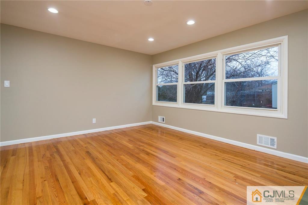 35 Purdue Road Old Bridge, NJ 08859 - Photo 11 of 21 a view of an empty room with a window and wooden floor