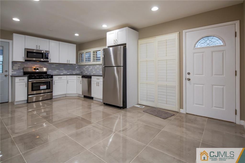 35 Purdue Road Old Bridge, NJ 08859 - Photo 7 of 21 a kitchen with stainless steel appliances granite countertop a refrigerator and a stove top oven