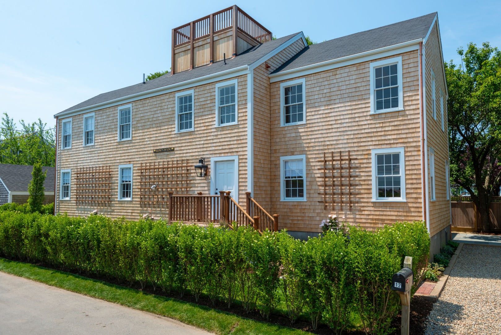 12 Willard Street Nantucket, MA 02554 - Photo 1 of 36 a front view of a house with a yard and green space