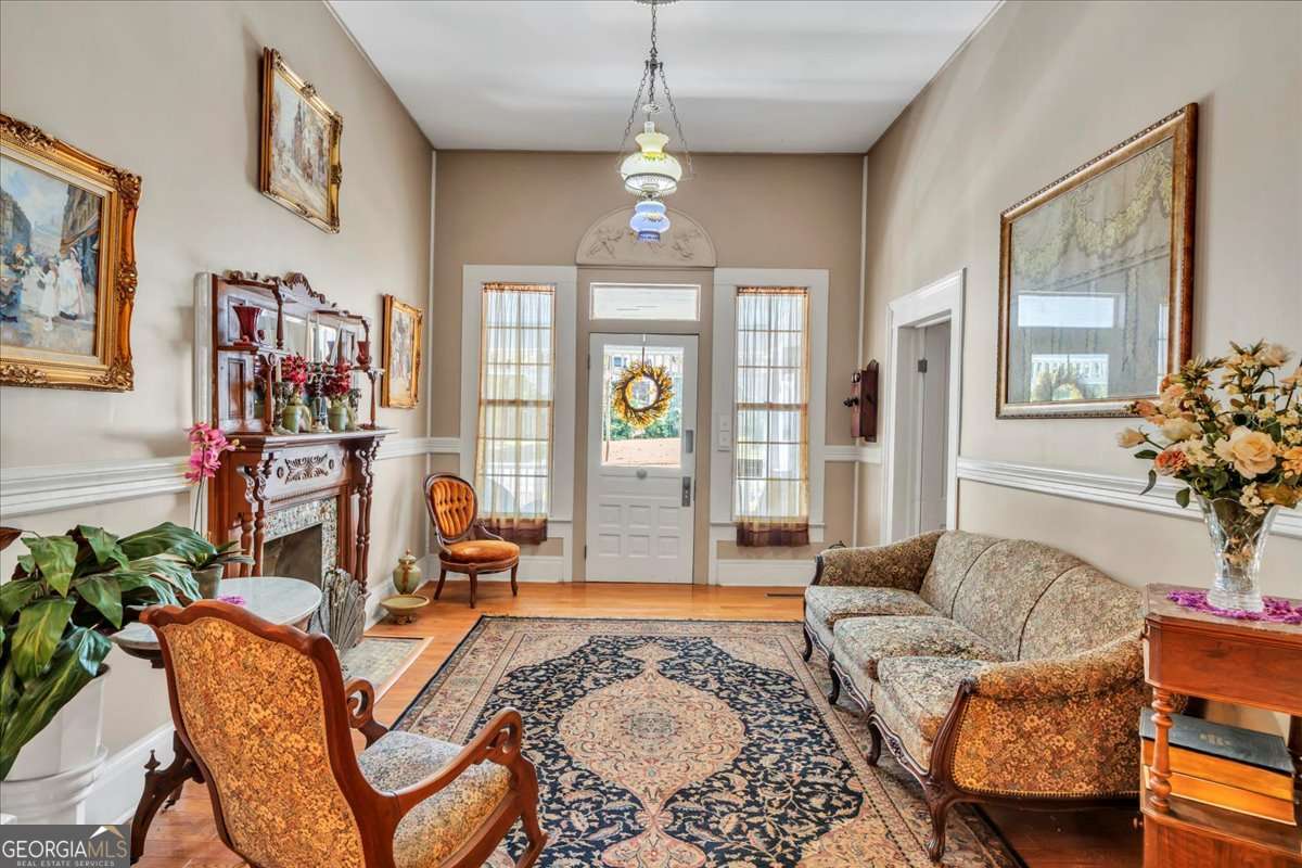212 East Union Street Vienna, GA 31092 - Photo 12 of 62 a living room with furniture a chandelier and a window