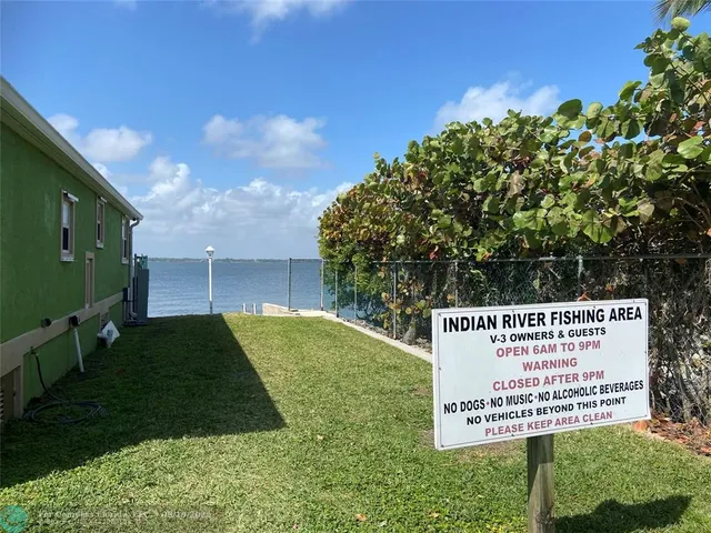 a room with wooden furniture and pool table