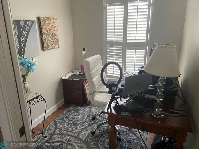 a view of workspace with wooden floor windows