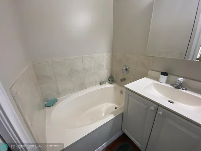 a bathroom with a white sink and a bathtub