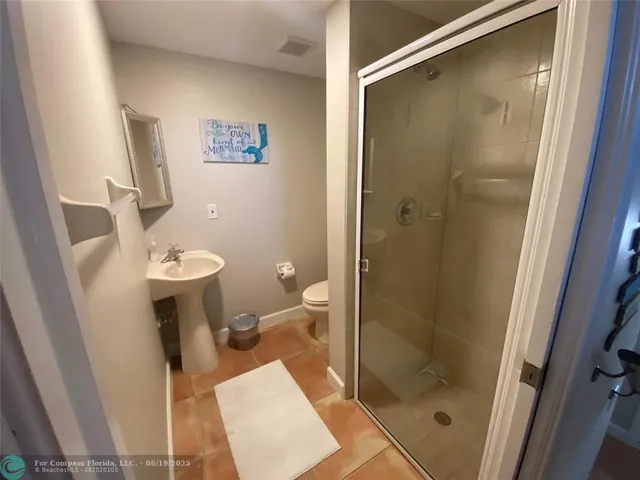 a bathroom with a shower and a toilet