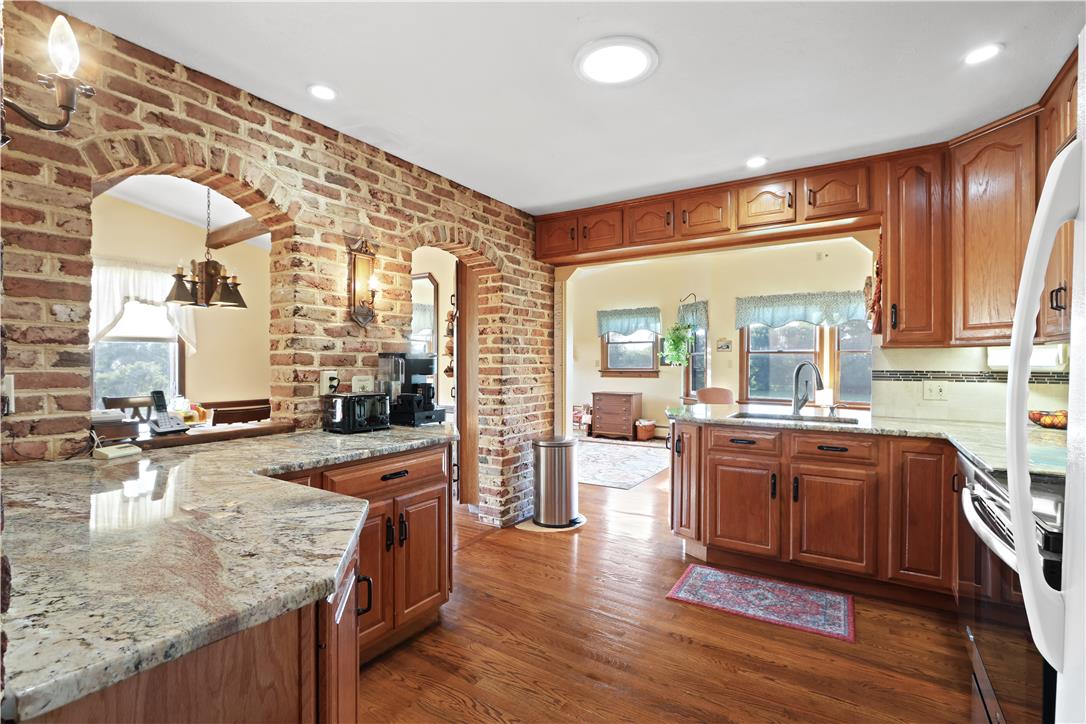 4938 Steuben Road Nazareth, PA 18064 - Photo 8 of 43 Granite counters and rich wood cabinetry define this inviting kitchen space.
