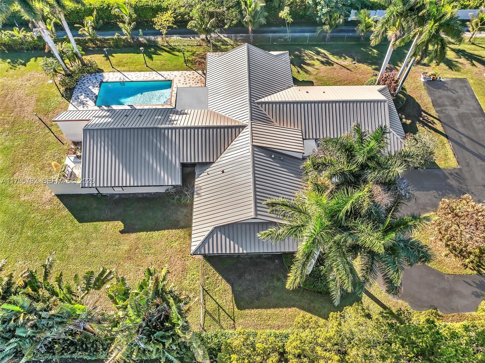 a view of a swimming pool with a patio and a lake view