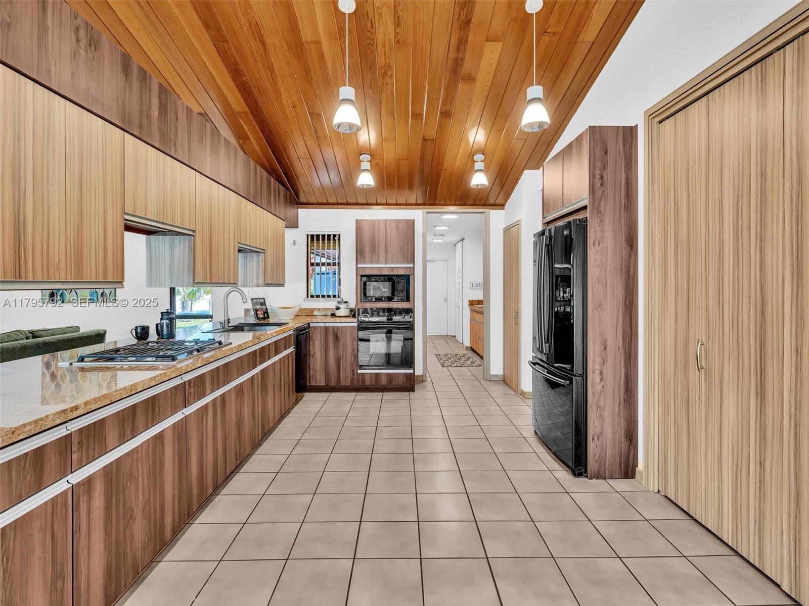 13494 Stirling Road Southwest Ranches, FL 33330 - Photo 22 of 79 a large kitchen with stainless steel appliances lots of counter space and a sink