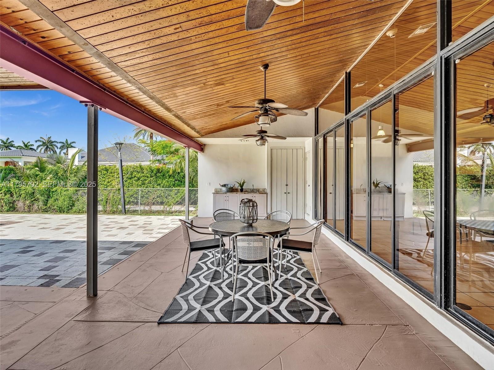 13494 Stirling Road Southwest Ranches, FL 33330 - Photo 67 of 79 a dining room with wooden floor and outdoor seating