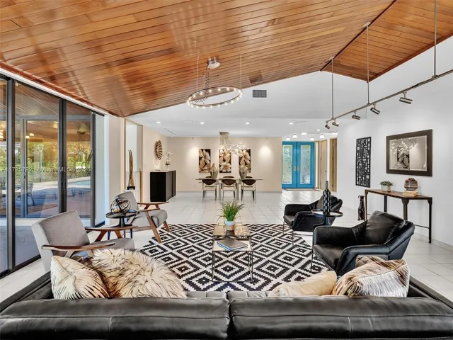 a bedroom with furniture and large windows