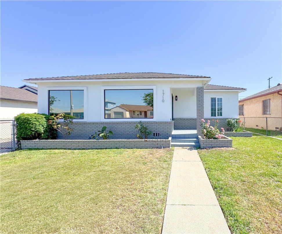 1710 West Arbutus Street Compton, CA 90220 - Photo 1 of 1 a view of a house with swimming pool and a yard