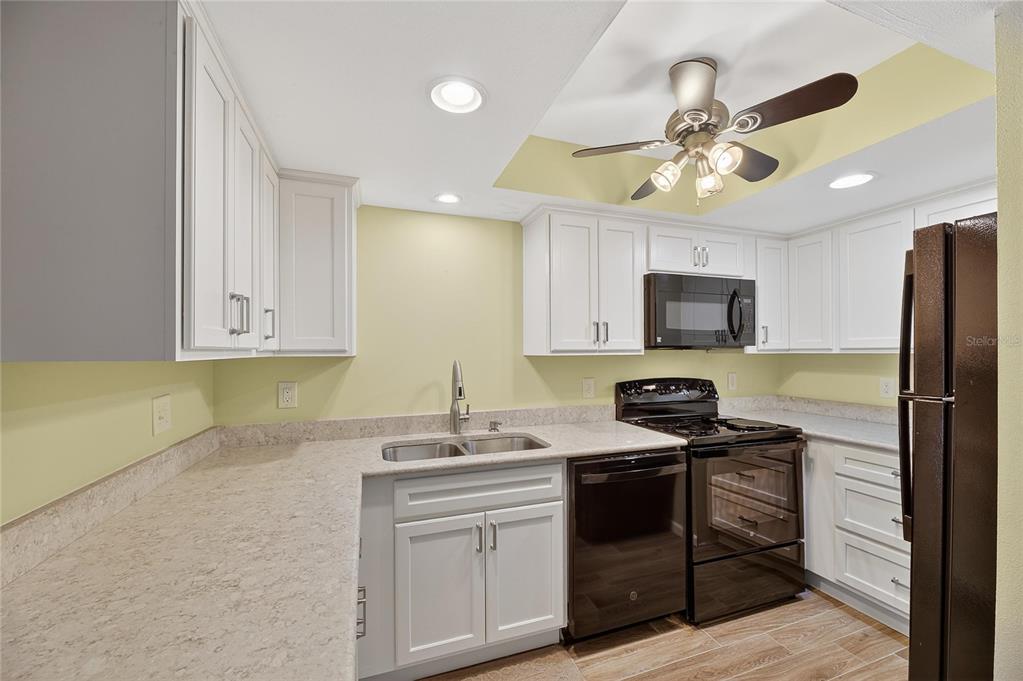 1028 Apollo Beach Boulevard, Unit 23 Apollo Beach, FL 33572 - Photo 13 of 86 a kitchen with stainless steel appliances a sink stove and refrigerator