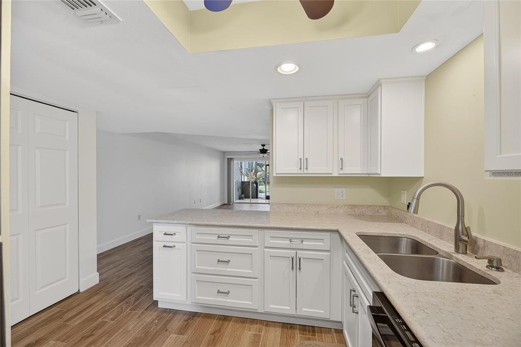 1028 Apollo Beach Boulevard, Unit 23 Apollo Beach, FL 33572 - Photo 15 of 86 a kitchen with cabinets appliances a sink and a counter top