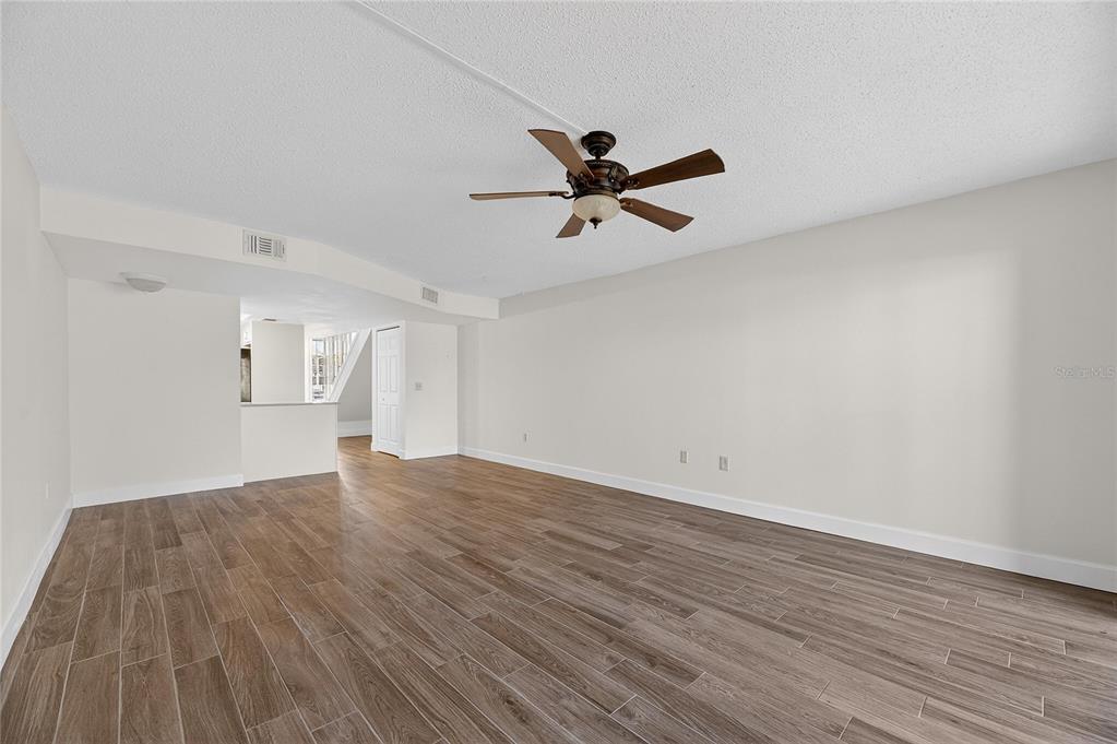 1028 Apollo Beach Boulevard, Unit 23 Apollo Beach, FL 33572 - Photo 26 of 86 a view of empty room with wooden floor and fan