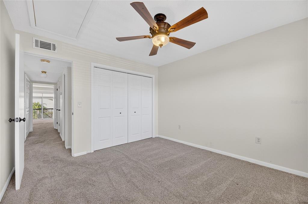 1028 Apollo Beach Boulevard, Unit 23 Apollo Beach, FL 33572 - Photo 48 of 86 an empty room with closet and a chandelier fan