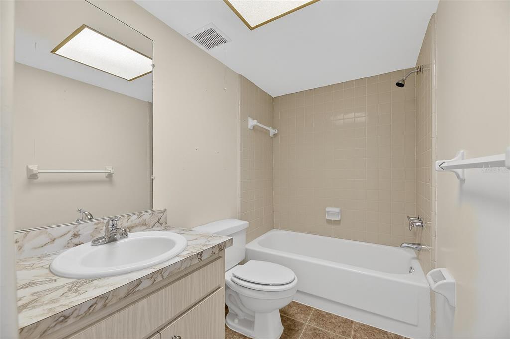 1028 Apollo Beach Boulevard, Unit 23 Apollo Beach, FL 33572 - Photo 50 of 86 a bathroom with a sink toilet vanity and shower