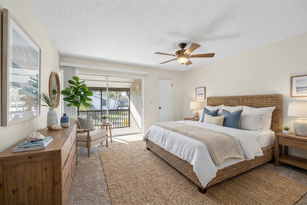 1028 Apollo Beach Boulevard, Unit 23 Apollo Beach, FL 33572 - Photo 54 of 86 a bedroom with a large bed and a chandelier