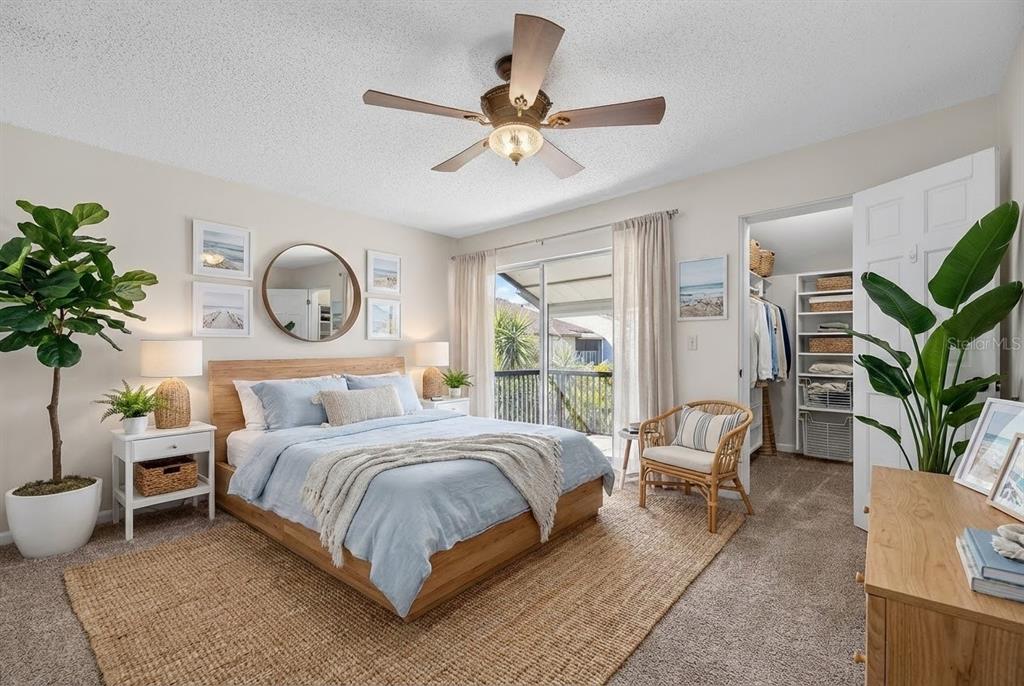 1028 Apollo Beach Boulevard, Unit 23 Apollo Beach, FL 33572 - Photo 58 of 86 a bedroom with a bed and a chandelier