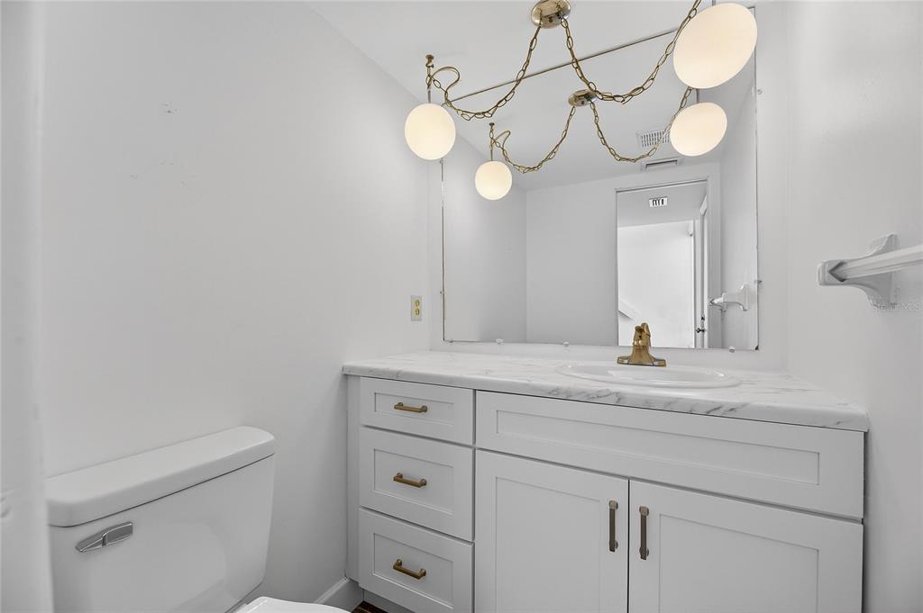 1028 Apollo Beach Boulevard, Unit 23 Apollo Beach, FL 33572 - Photo 9 of 86 a bathroom with a sink a mirror and vanity