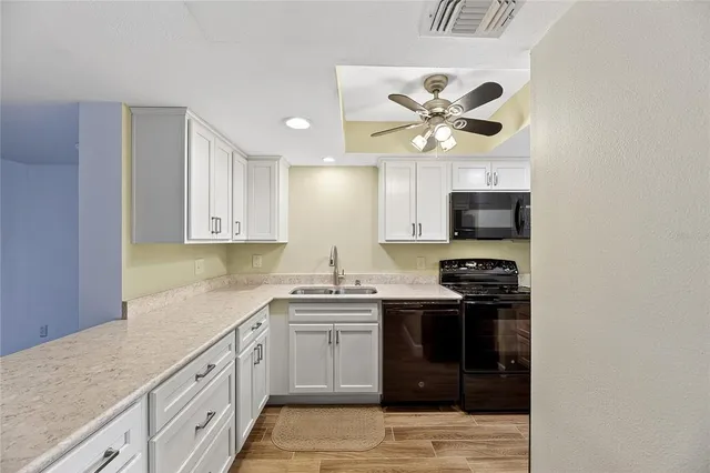 a kitchen with stainless steel appliances a sink stove and refrigerator
