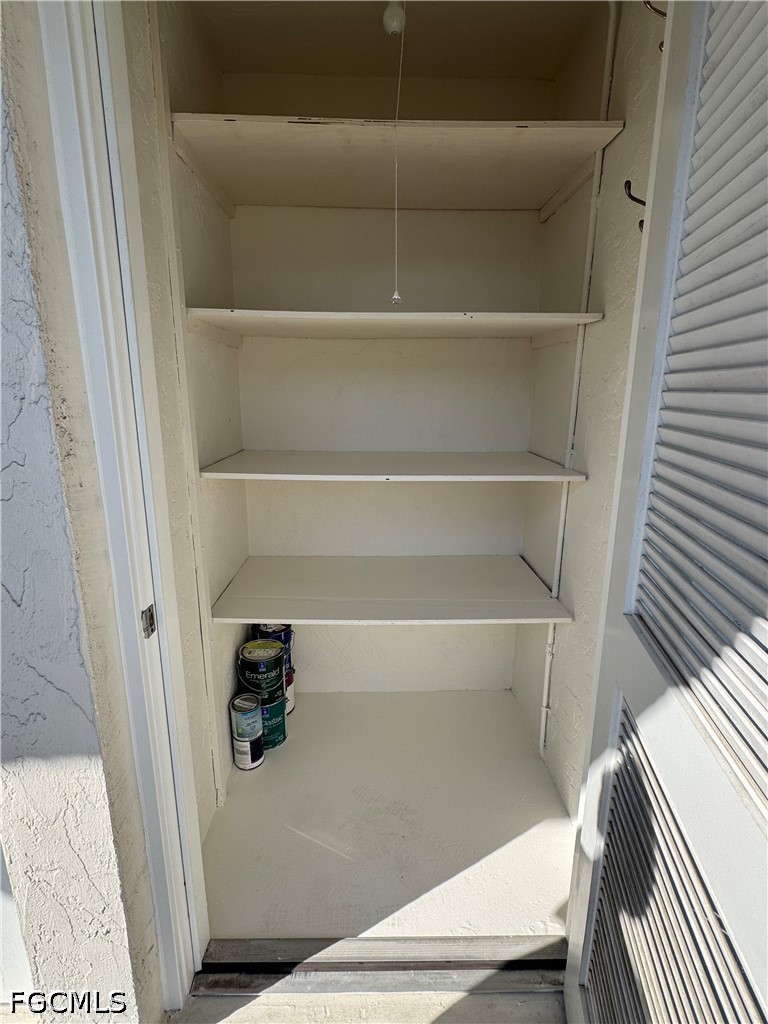 53 High Point Circle West, Unit 204 Naples, FL 34103 - Photo 25 of 50 a view of walk in closet with empty racks