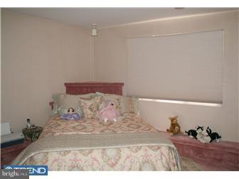 51 Tulip Road Southampton, PA 18966 - Photo 11 of 12 a bedroom with a bed and a lamp