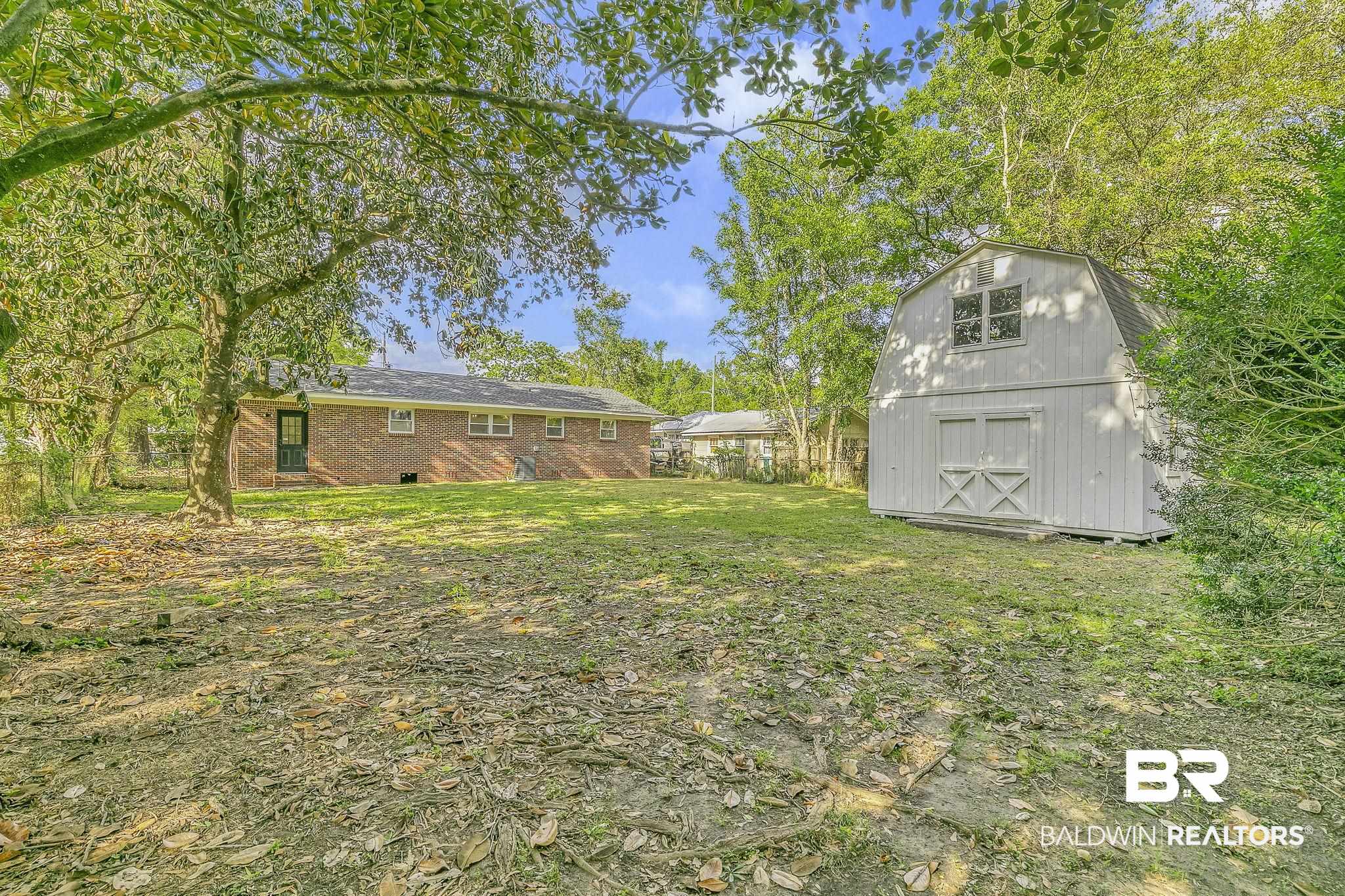 203 Anderson Road Saraland, AL 36571 - Photo 37 of 48 View of yard featuring a shed and an outdoor structure