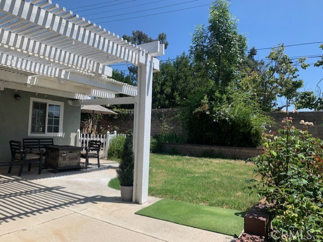 2138 Clear Springs Road Brea, CA 92821 - Photo 10 of 10 a view of a patio with table and chairs potted plants with wooden floor and fence