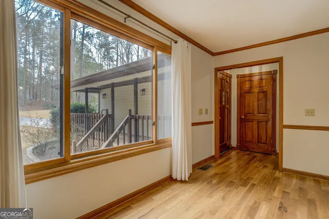 a kitchen with a stove and wooden floor