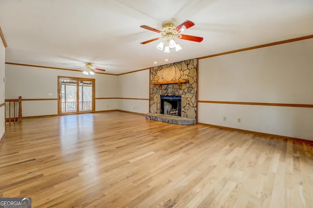 a kitchen with stainless steel appliances granite countertop a stove a sink and a refrigerator with wooden floor