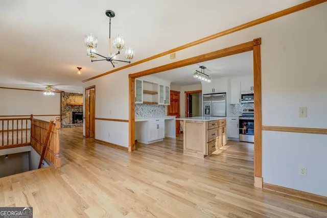 an empty room with a window and a ceiling fan