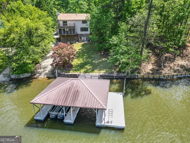 an aerial view of a house with a yard and garden