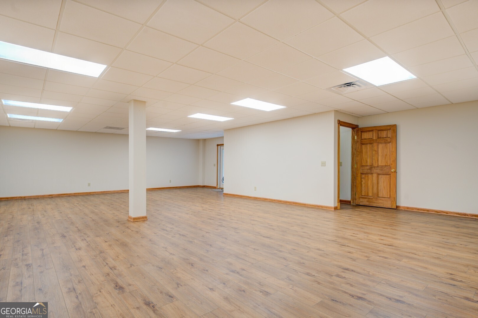 71 Canvasback Court Monticello, GA 31064 - Photo 61 of 79 a view of an empty room with wooden floor and closet