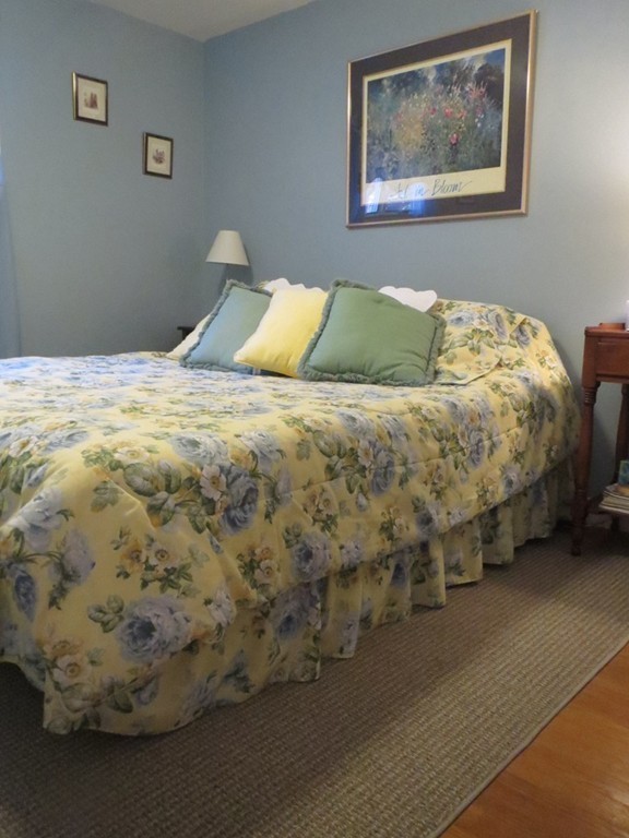 84 Genesee Street Lawrence, MA 01843 - Photo 13 of 30 a bedroom with a bed and a painting on the wall