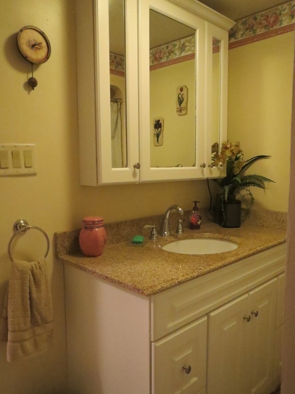 84 Genesee Street Lawrence, MA 01843 - Photo 14 of 30 a bathroom with a granite countertop sink and a mirror