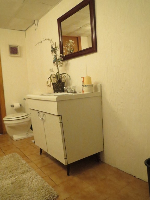 84 Genesee Street Lawrence, MA 01843 - Photo 20 of 30 a utility room with a sink a toilet and a mirror