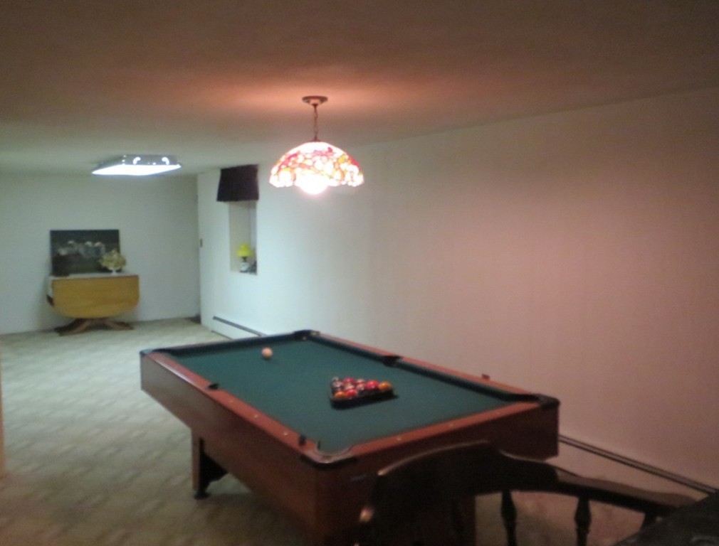 84 Genesee Street Lawrence, MA 01843 - Photo 21 of 30 a room with pool table and chandelier