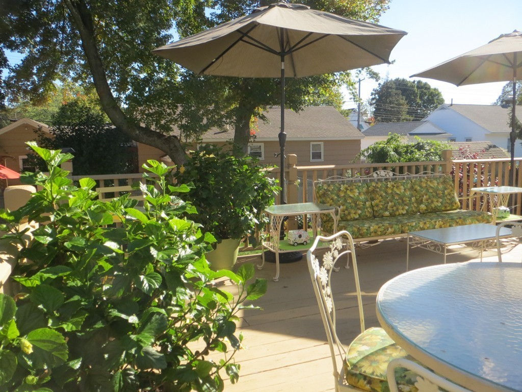 84 Genesee Street Lawrence, MA 01843 - Photo 25 of 30 a view of a patio with chairs under an umbrella