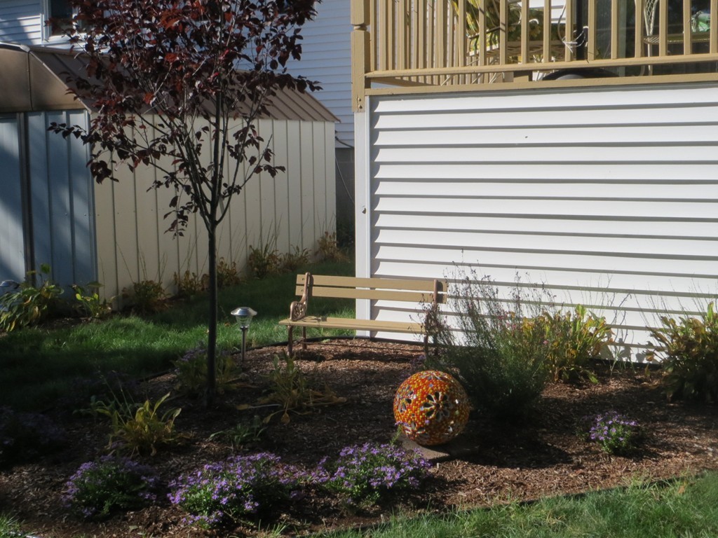84 Genesee Street Lawrence, MA 01843 - Photo 29 of 30 a view of a backyard with plants and a patio