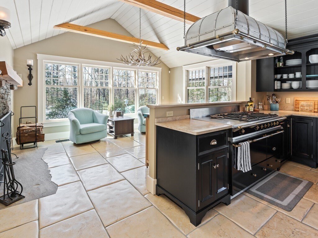 49 Greene Road Princeton, MA 01541 - Photo 12 of 42 a kitchen with a stove top oven cabinets a dining table and chairs