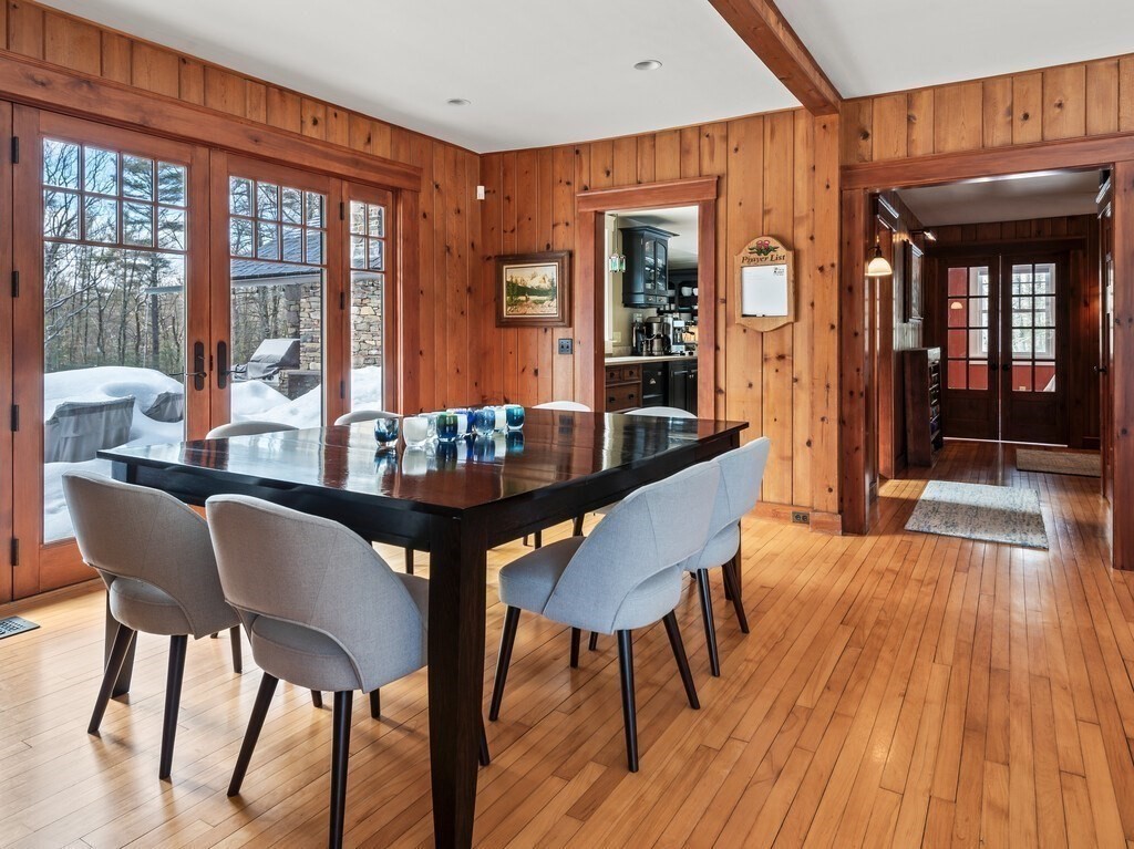 49 Greene Road Princeton, MA 01541 - Photo 17 of 42 a dining room with furniture wooden floor and a chandelier