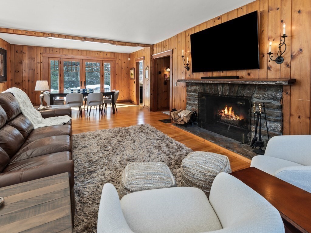 49 Greene Road Princeton, MA 01541 - Photo 20 of 42 a living room with furniture a flat screen tv and a fireplace