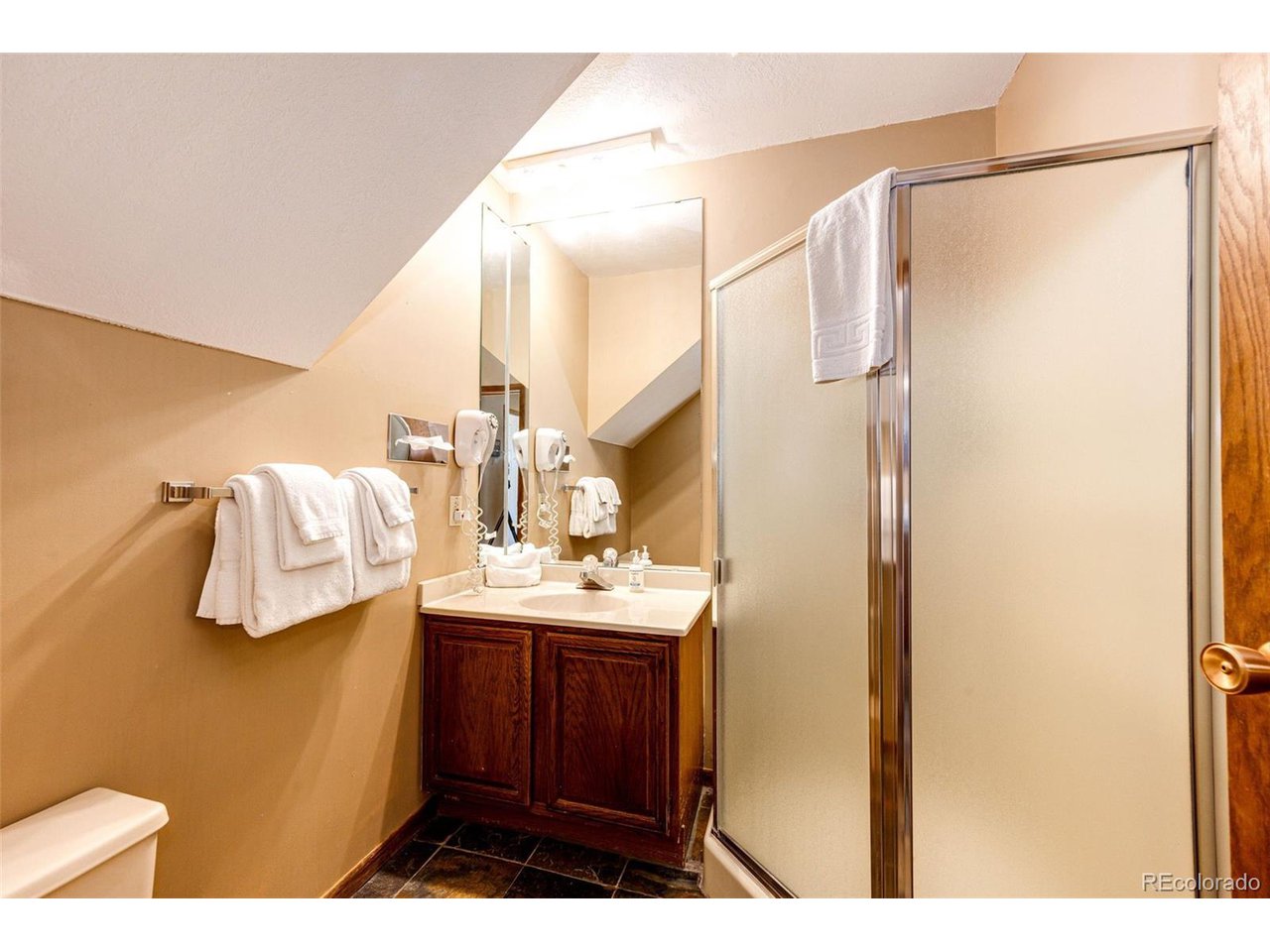 96 Mountainside Drive, Unit 47 Granby, CO 80446 - Photo 11 of 42 a bathroom with a sink and mirror with shower