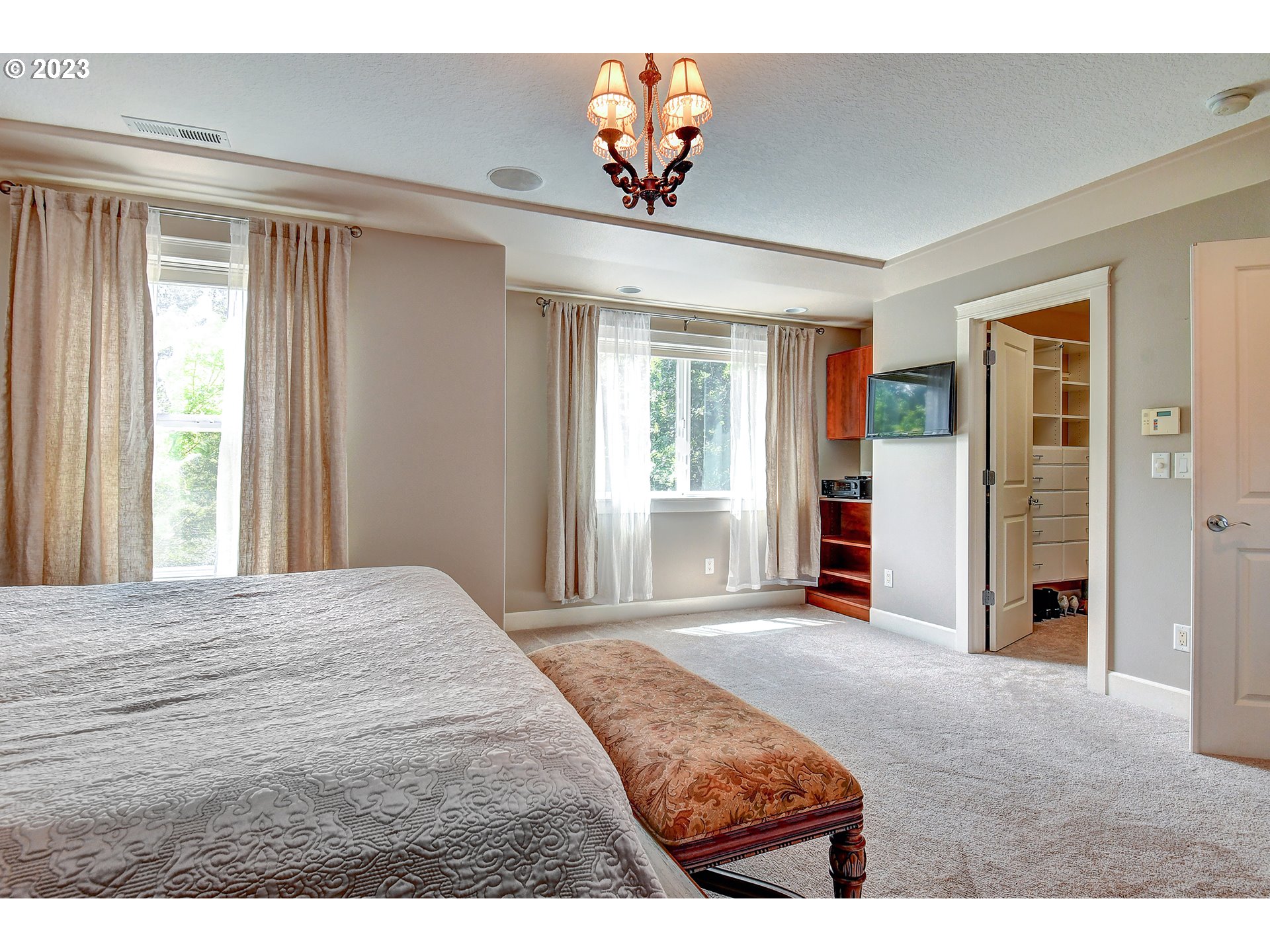 907 North 7th Circle Ridgefield, WA 98642 - Photo 20 of 47 a bedroom with a bed and a chandelier
