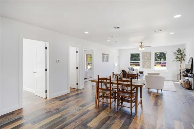 a large kitchen with a table and chairs