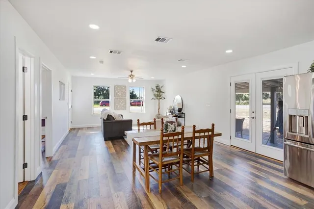a kitchen with granite countertop a refrigerator and a stove top oven