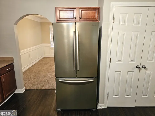 a kitchen with granite countertop a stove top oven cabinetry a sink and a window