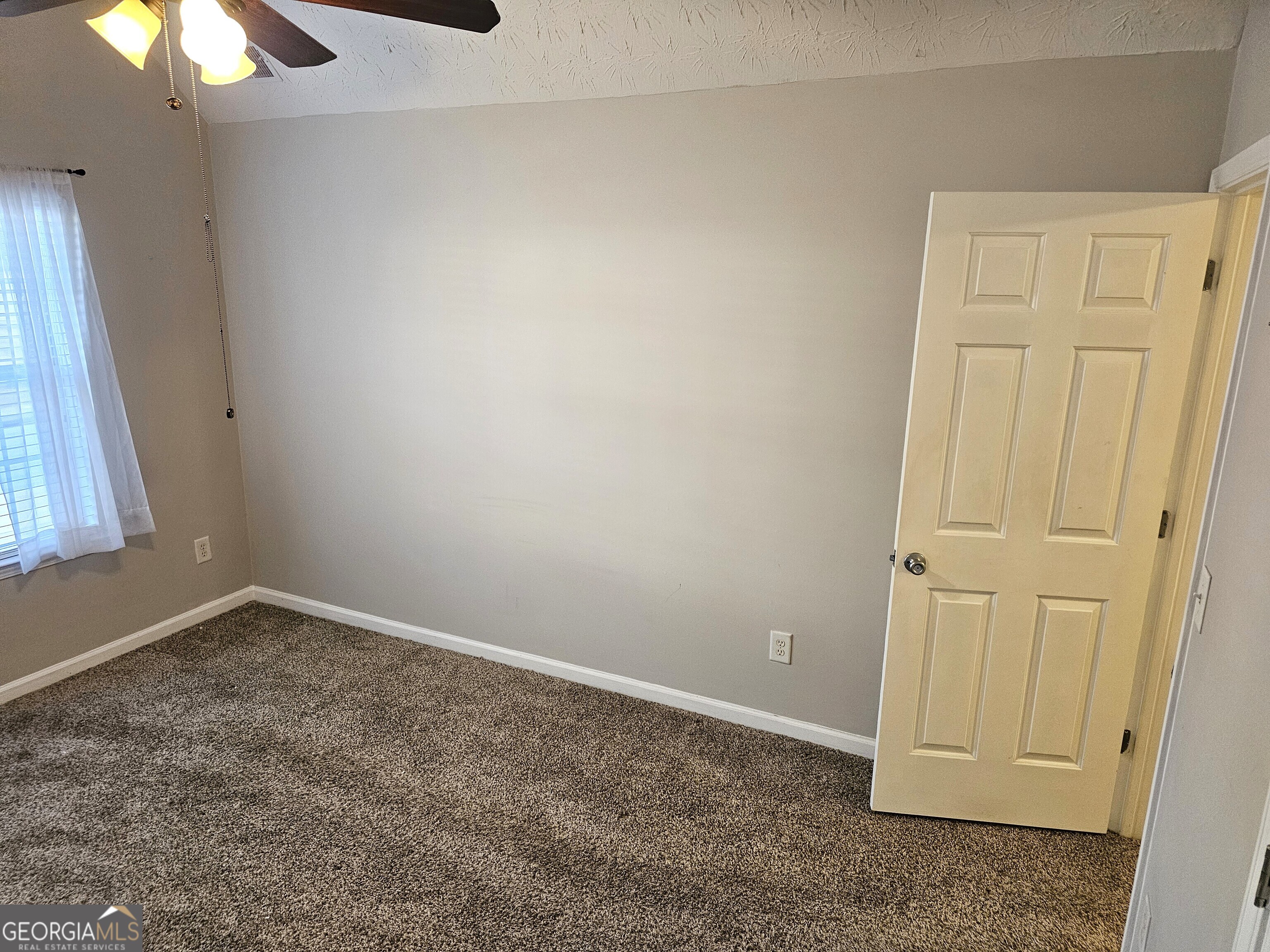 11223 Genova Terrace Hampton, GA 30228 - Photo 21 of 26 an empty room with a window