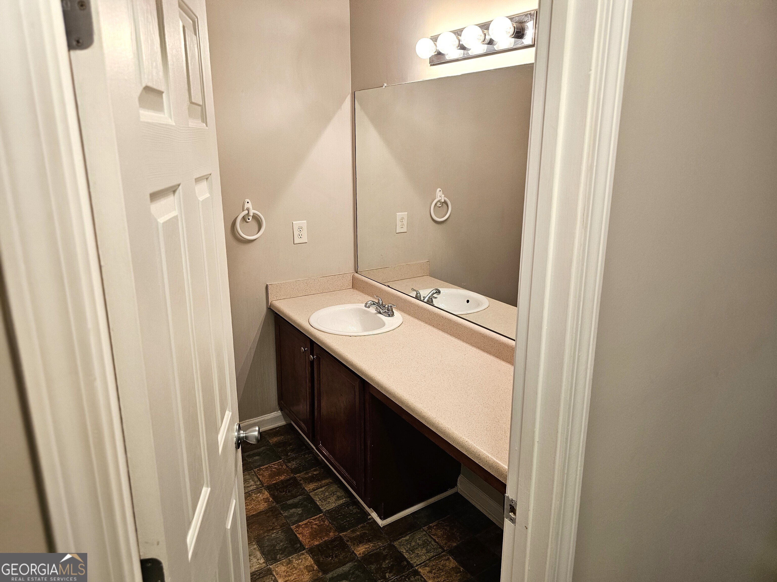11223 Genova Terrace Hampton, GA 30228 - Photo 22 of 26 a bathroom with a sink a mirror and a shower